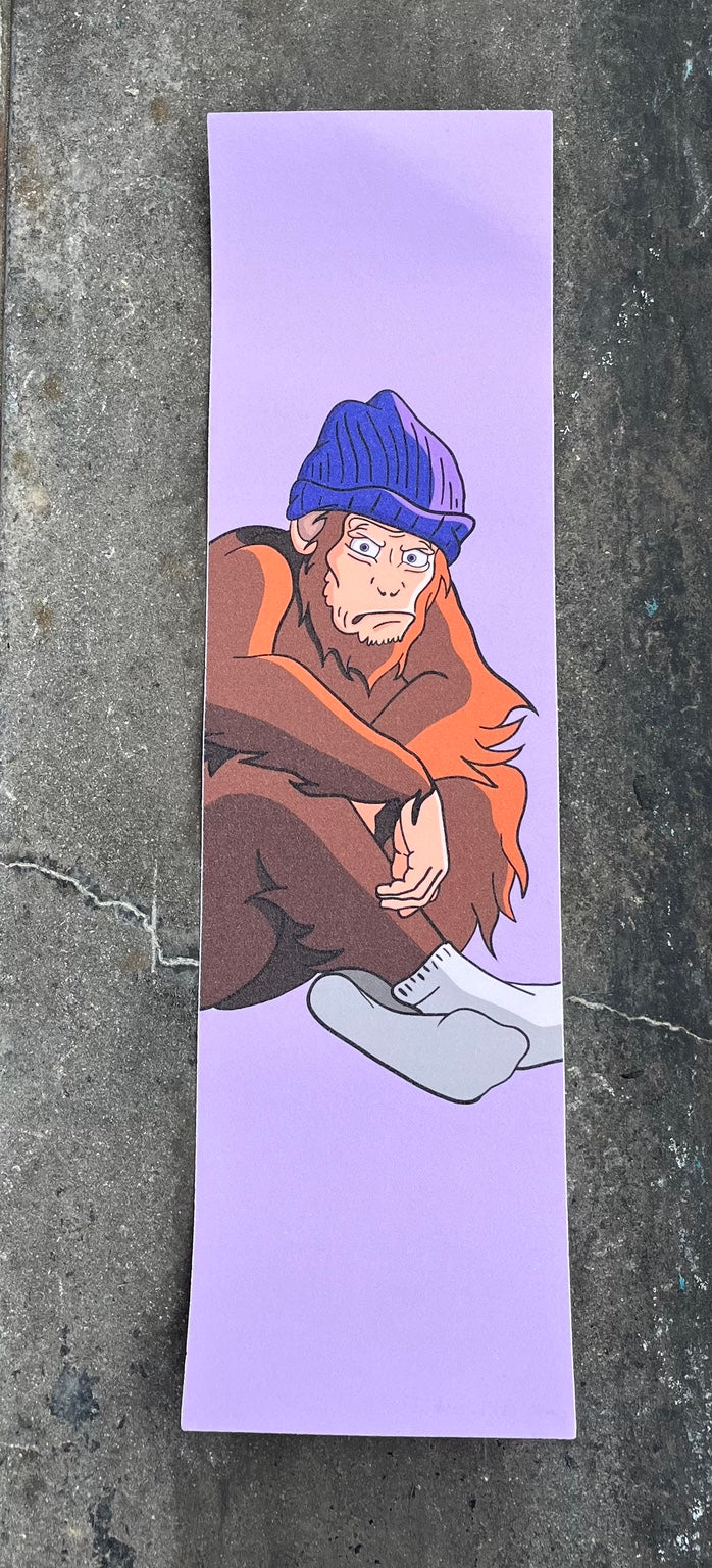 Baffled Panda Monkey graphic skateboard grip tape photographed on skatepark concrete